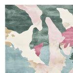 A vibrant, hand-tufted area rug featuring an abstract watercolor terrain design in shades of pink, teal, and cream. This wool rug is perfect for adding a contemporary touch to living room spaces. The square rug showcases a unique pattern, making it an ideal choice for those seeking stylish living room area rugs.