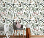 Watercolor tropical jungle wallpaper with monkeys and pineapples in nursery with grey chair and crib