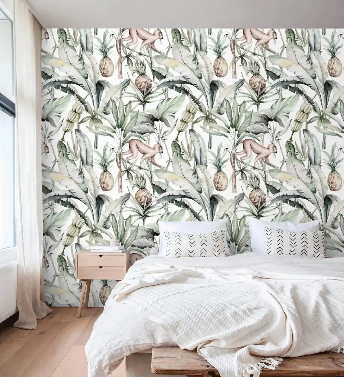 Watercolor tropical jungle wallpaper with palms and monkeys in bedroom with white bedding and wood nightstand