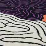 Close-up of a textured surface with wavy lines in black, white, and purple.