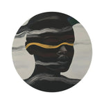 Waves of Identity Round Rug flat lay, abstract dark face split by white wave lines and a gold band on grey-cream ground