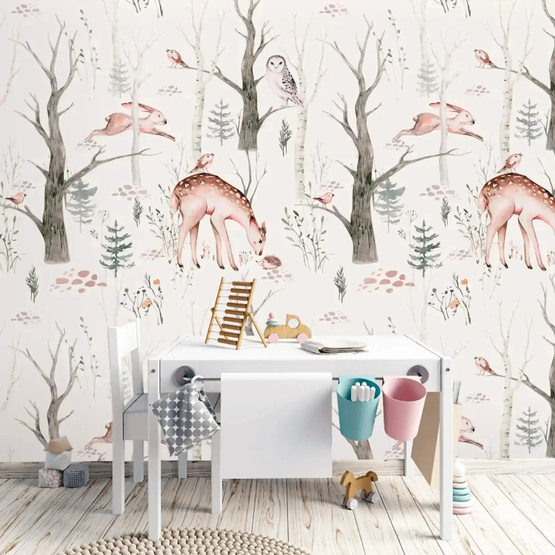 Whimsical Enchanted Forest wallpaper of deer and owls in bare trees behind a white kids' desk
