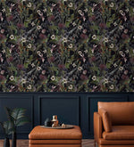 Whimsical vintage garden wallpaper with daisies and thistles on black above navy panelling and tan leather seating