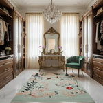 Luxurious bedroom with floral rug, ornate mirror, and green chair.