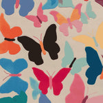 A vibrant area rug featuring a hand-tufted design of colorful butterflies in shades of orange, pink, blue, and black. This wool rug adds a lively touch to any living room, creating an inviting atmosphere with its playful and artistic pattern.