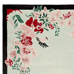 Beautiful hand-tufted area rug featuring a vibrant floral design with pink and red blooms, complemented by lush green leaves. This wool rug is perfect for adding a touch of elegance to large living room spaces.