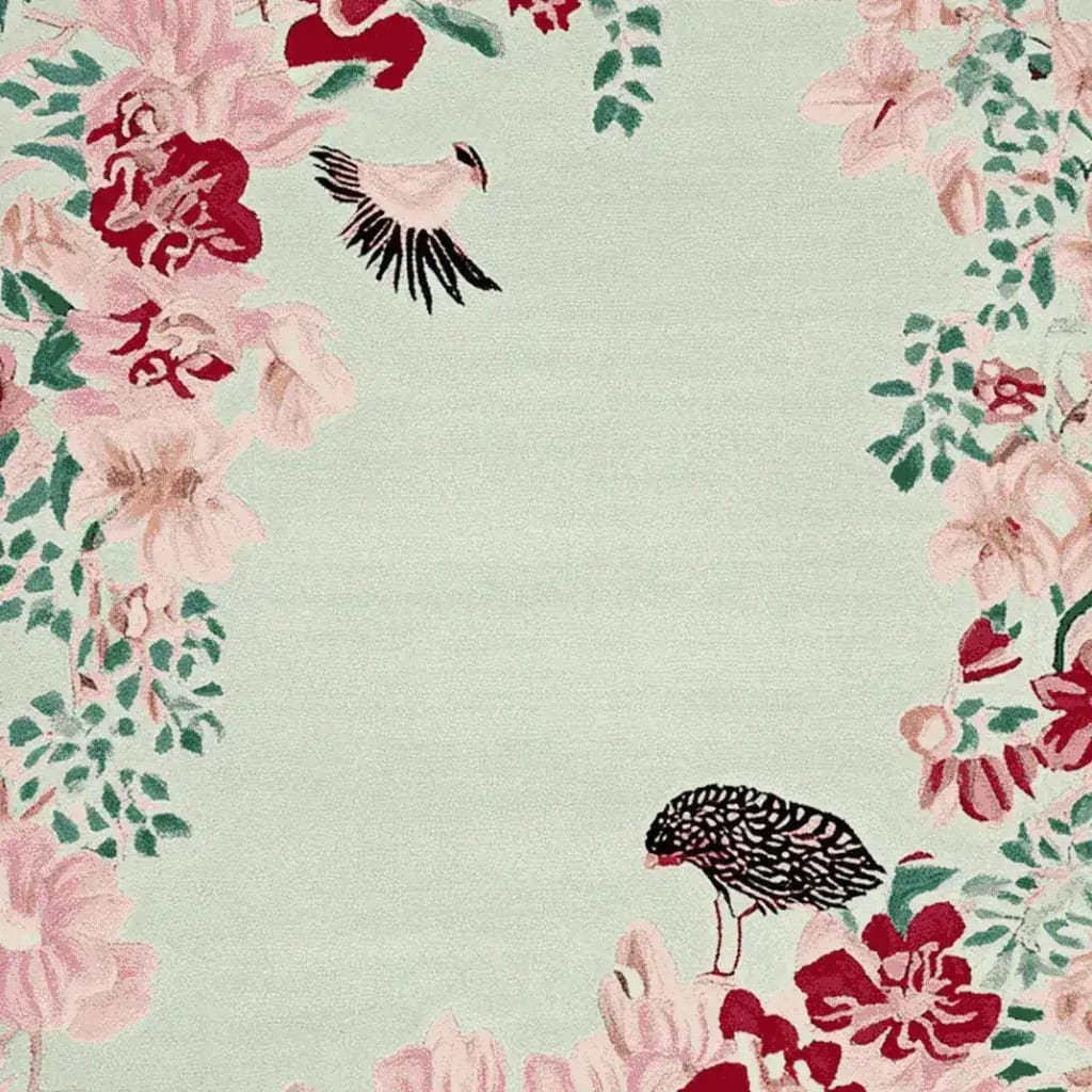 A beautiful hand-tufted area rug showcasing a delicate floral design with birds, perfect for adding elegance to large living rooms. This wool rug features soft pink and red blossoms with lush green leaves on a light background, creating a whispering bloom tale.