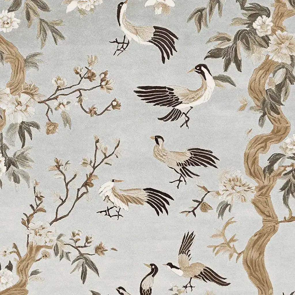 Elegant area rug featuring a hand-tufted wool design with a whimsical pattern of birds and blossoms on a soft blue background, perfect for large living room spaces.