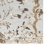 Beautifully detailed area rug showcasing a nature-inspired design with birds and branches, perfect for large living room spaces. This hand-tufted wool rug features a soft color palette, adding elegance to any living room area.