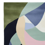 A vibrant Whispering Color Flow Hand Tufted Rug showcasing an abstract design with soft hues of green, blue, pink, and beige. Perfect as an area rug for the living room, this 8x10 wool contemporary rug adds a touch of elegance and modern style.