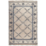 The Whispering Vines Hand Knotted Rug is a stunning area rug featuring intricate vine patterns in shades of blue and black on a beige background. This wool rug, perfect for adding a touch of elegance to your living room, combines traditional craftsmanship with a vintage charm. Ideal as an area rug for living rooms, it brings both style and comfort to any space.