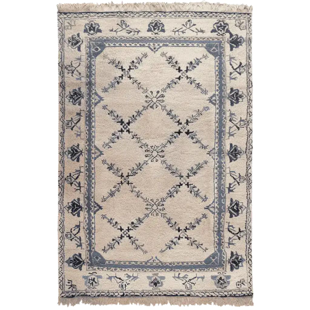 The Whispering Vines Hand Knotted Rug is a stunning area rug featuring intricate vine patterns in shades of blue and black on a beige background. This wool rug, perfect for adding a touch of elegance to your living room, combines traditional craftsmanship with a vintage charm. Ideal as an area rug for living rooms, it brings both style and comfort to any space.