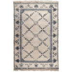 The Whispering Vines Hand Knotted Rug is a stunning area rug featuring intricate vine patterns in shades of blue and black on a beige background. This wool rug, perfect for adding a touch of elegance to your living room, combines traditional craftsmanship with a vintage charm. Ideal as an area rug for living rooms, it brings both style and comfort to any space.
