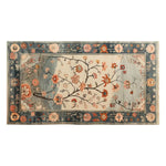Top view of the Whispers of the Dawn Knotted Wool Rug, featuring a beautiful floral pattern with vibrant blooms and intricate branches. This area rug, perfect for a living room, measures 8x10 and adds a touch of elegance and warmth with its delicate design and rich colors.