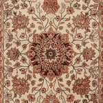 Intricate floral design of the Whispers of the Persian Garden Hand Tufted Rug showcasing a rich, vintage pattern in warm earthy tones. Perfect as an area rug, this 8x10 wool rug adds elegance to any living room, reminiscent of traditional Persian rugs.