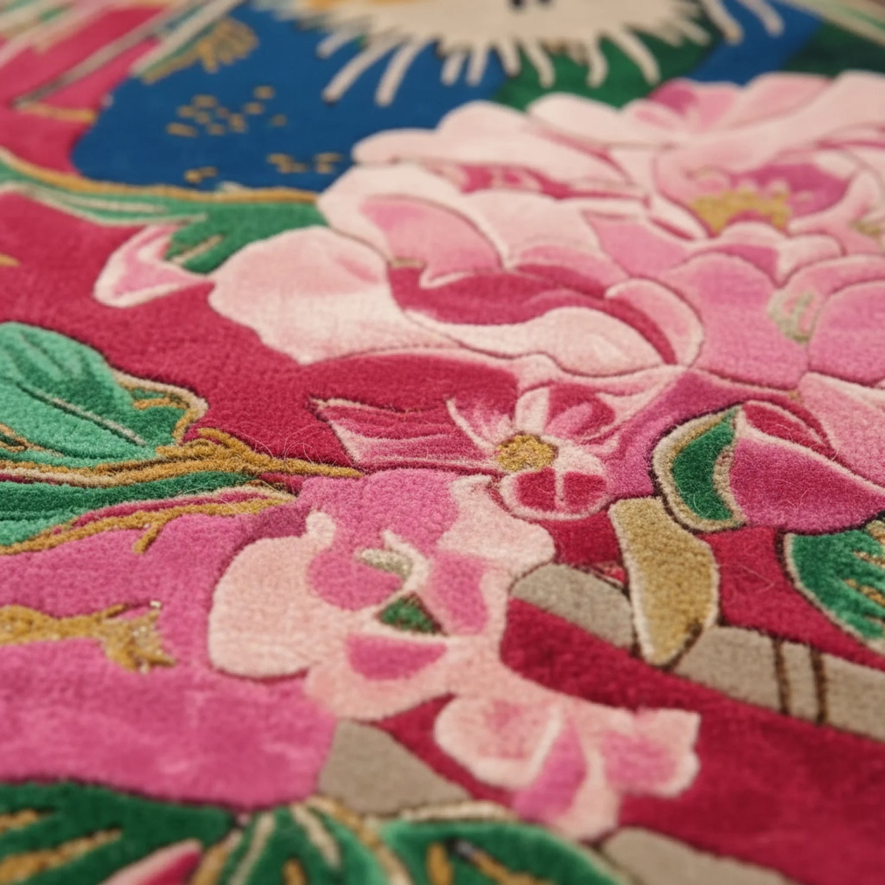 Close-up of embroidered rug with pink flowers and green leaves