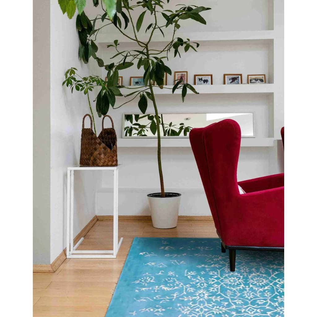 Elegant living room featuring a White Bloom Elegant Hand Tufted Viscose Rug in blue. This area rug adds a touch of vintage charm with its intricate design, perfect for large living room spaces. The red armchair and indoor plant complement the rug beautifully, creating a cozy and stylish atmosphere.