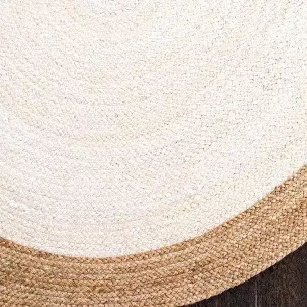 A close-up view of a white oval jute area rug, perfect for adding a natural touch to living room decor. This elegant rug showcases a braided pattern, making it an ideal choice for those looking for stylish rugs for living room spaces.