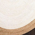 A close-up view of a white oval jute area rug, perfect for adding a natural touch to living room decor. This elegant rug showcases a braided pattern, making it an ideal choice for those looking for stylish rugs for living room spaces.