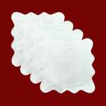 Stack of white scallop linen square placemats with wavy stitched border, fanned view on red background
