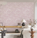 White sofa and wood bench against pink floral sketch wallpaper of white outlined flowers