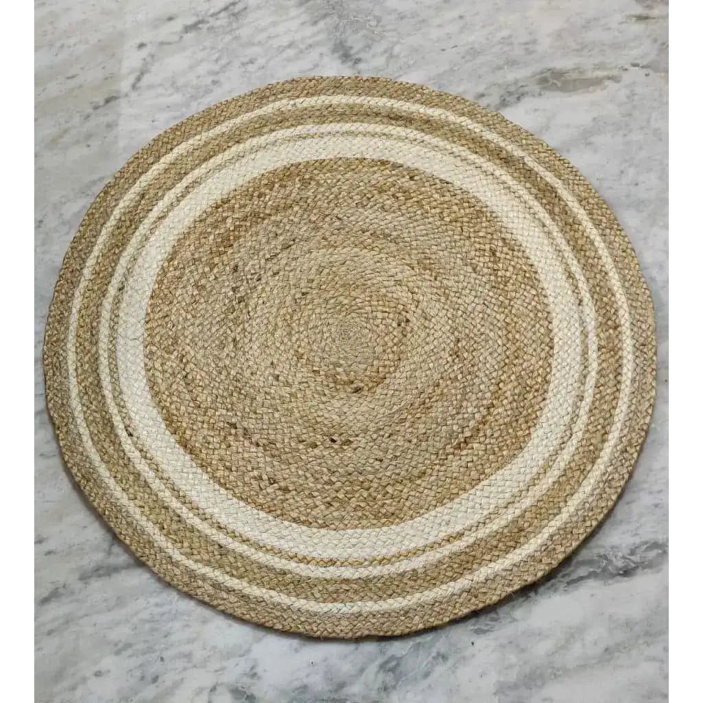 A beautifully hand-braided round jute rug with white trim, perfect for adding a boho touch to any dining room. This natural area rug features intricate weaving that complements formal dining room settings and enhances the cozy vibe of your space.
