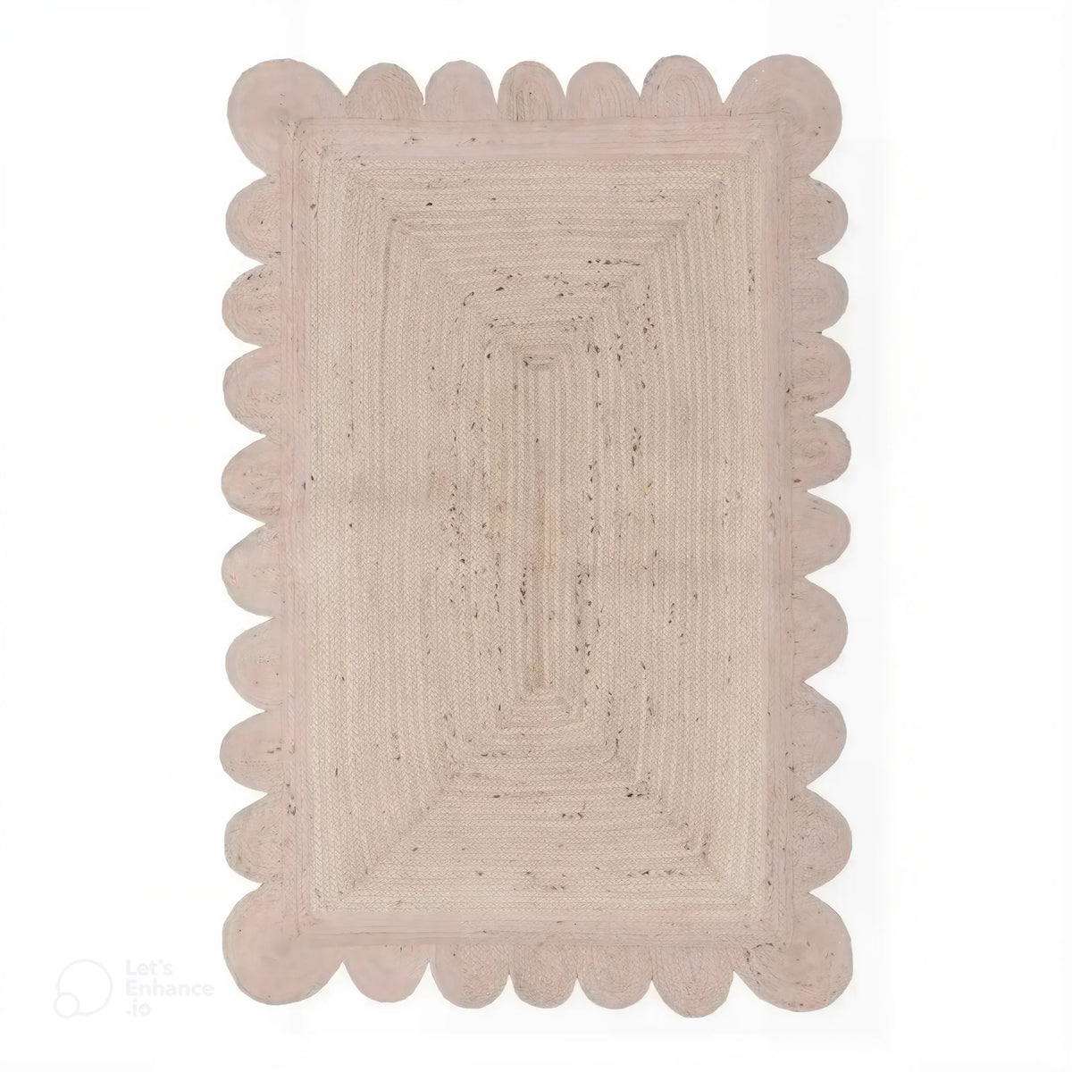 Top view of a Handmade Scalloped Jute Rug in soft white wash, 2 x 3 ft, with scalloped edges, placed in a living room setting.