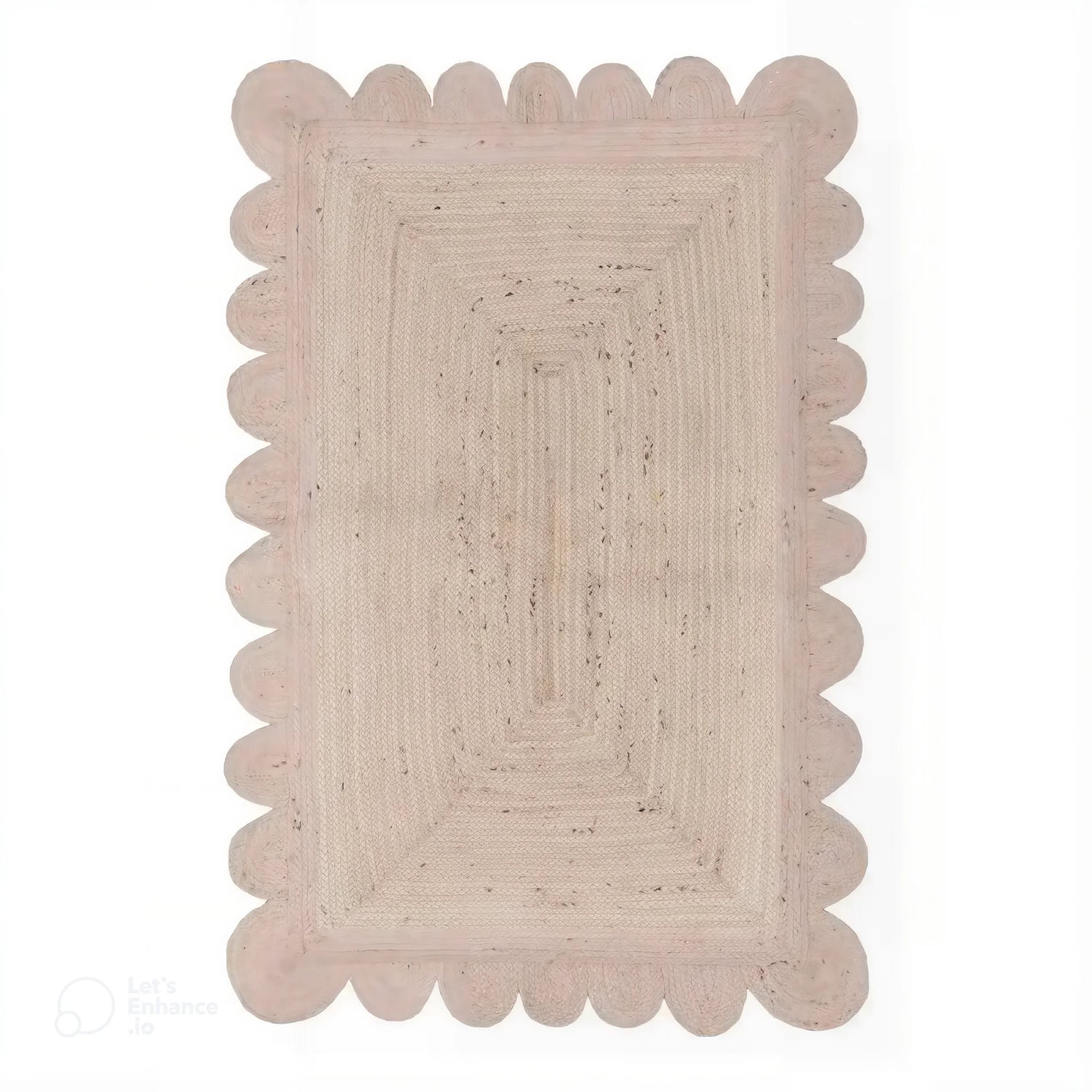 Top view of a Handmade Scalloped Jute Rug in soft white wash, 2 x 3 ft, with scalloped edges, placed in a living room setting.