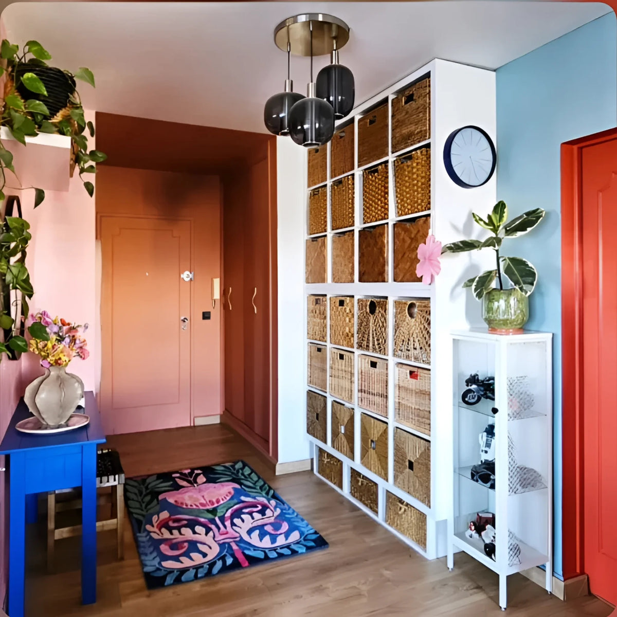 Wider entry view of the navy floral rug beside cubby shelving with woven baskets