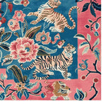 Vibrant Wild Bloom Dance Hand Tufted Area Rug featuring a lively design with tigers and floral patterns. This wool rug is perfect for adding an artistic touch to your living room. The square area rug showcases a bold mix of blue and pink hues, making it an eye-catching piece among square rugs and area rugs for living room spaces.