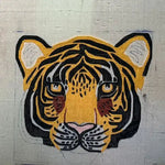 Hand-tufted wool area rug featuring an abstract tiger face design. Ideal for adding a wild touch to your living room or dining room, this eye-catching rug serves as a unique dining room area rug or carpet.