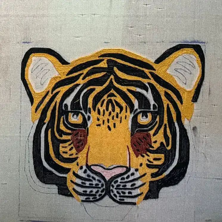 Hand-tufted wool area rug featuring an abstract tiger face design. Ideal for adding a wild touch to your living room or dining room, this eye-catching rug serves as a unique dining room area rug or carpet.