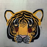 Hand-tufted wool area rug featuring an abstract tiger face design. Ideal for adding a wild touch to your living room or dining room, this eye-catching rug serves as a unique dining room area rug or carpet.