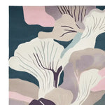 Top view of the Wild Grove Bloom Hand Tufted Area Rug, featuring a contemporary abstract floral design in soft pink, cream, and muted tones. This wool rug adds a sophisticated touch to any living room with its modern aesthetic and intricate pattern.
