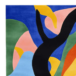 Vibrant abstract design on a hand tufted wool area rug, perfect for large living rooms. This square contemporary rug features bold splashes of blue, green, pink, yellow, and black, creating a striking visual centerpiece.