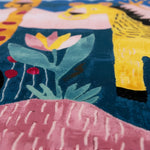 Close-up of a colorful rug with floral patterns and a person wearing a yellow shirt.