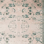 The Willow Grace Hand Tufted Rug features an elegant vintage design with intricate floral patterns in shades of green and cream. This wool area rug, sized 8x10, is perfect for adding a touch of sophistication to living room spaces.