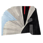 Contemporary hand-tufted area rug in an abstract design, featuring a blend of soft blues, creams, and bold blacks with subtle red accents, perfect for large living rooms. This wool rug adds a modern touch to any living space.