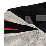 Contemporary area rug featuring an abstract design with bold black, grey, and red patterns. This wool rug is ideal for large living rooms, adding a modern touch to your decor.