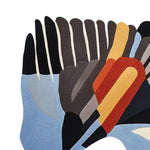 Abstract design of the Wings in Motion Hand Tufted Area Rug. This wool rug features a contemporary pattern with bold colors, ideal for living room rugs 8x10.