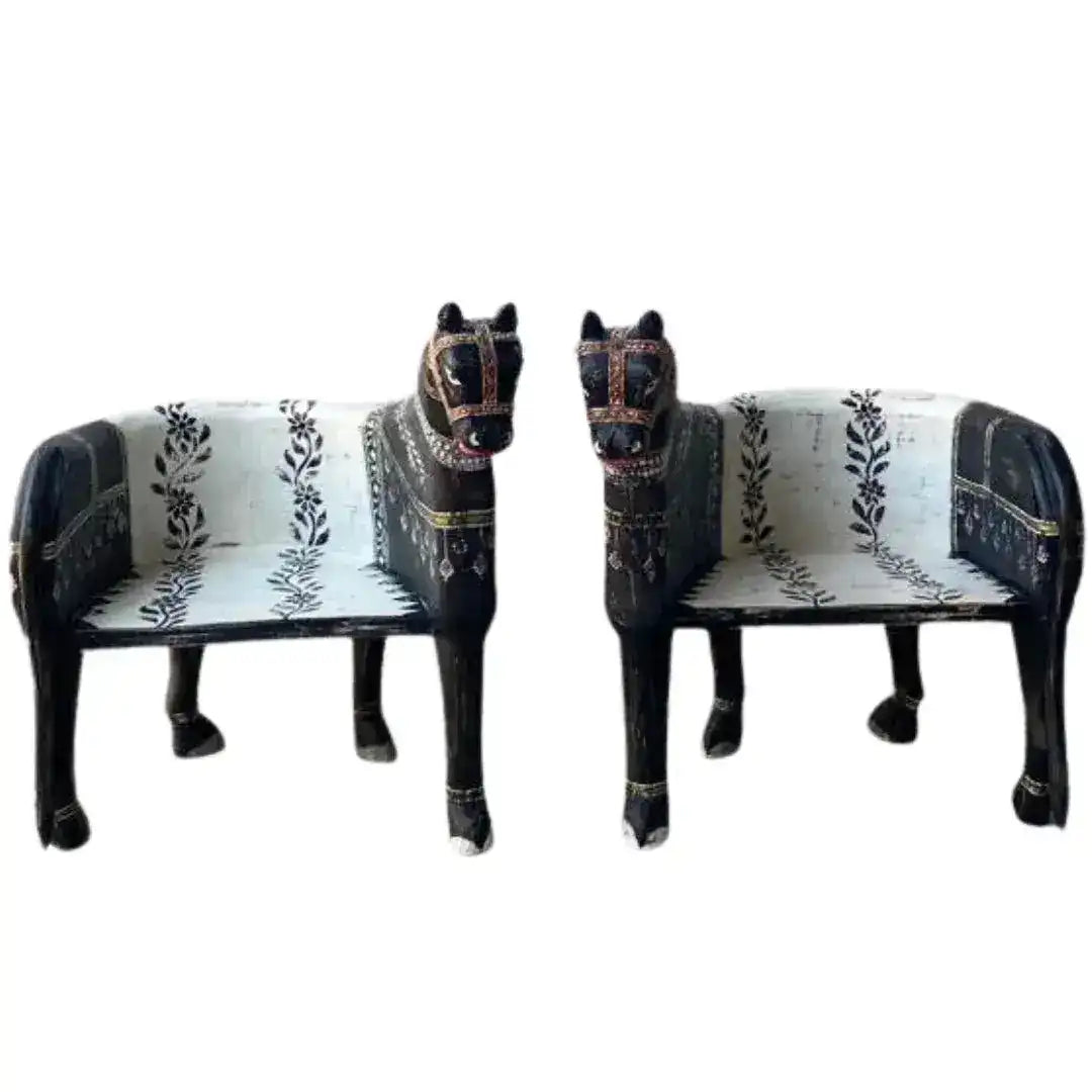 Pair of Wooden Horse Maharaja Chairs — black lacquered carved wood with white floral-embroidered seat, front view.