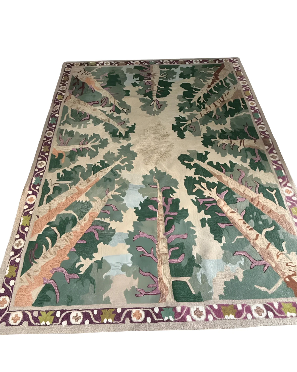 Decorative rug with tree design on a green background