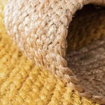 Close-up of a yellow rectangular jute rug showcasing its intricate woven texture, perfect as an area rug for a boho-themed bedroom. Ideal for adding a natural touch to bedroom decor.