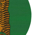 Close-up view of the Yellow Tibetan Tiger Green Hand Tufted Round Rug, showcasing the intricate tiger design in warm tones against a lush green backdrop. This wool area rug is perfect for adding a bold statement to your living room or dining room, making it an ideal area rug for under a dining table.