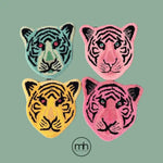 Vibrant, hand-tufted wool area rug featuring abstract tiger faces in yellow, pink, and blue. Perfect for adding a bold touch to living room or dining room spaces, these accent rugs offer a unique and stylish addition to any home decor.
