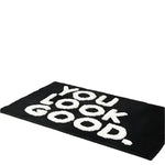 Stylish black area rug featuring bold white text saying 'You Look Good', perfect for adding a modern touch to rugs for living room or as a standout living room area rug.