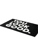 Stylish black area rug featuring bold white text saying 'You Look Good', perfect for adding a modern touch to rugs for living room or as a standout living room area rug.