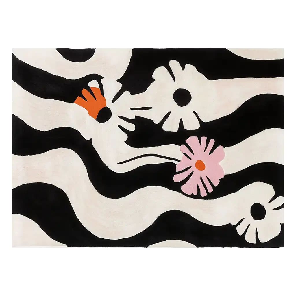 Top view of the Zebra Bloom Hand Tufted Wool Rug, featuring a striking black and white zebra stripe pattern with abstract floral designs in orange and pink. This contemporary area rug is perfect for adding a bold touch to your living room decor.
