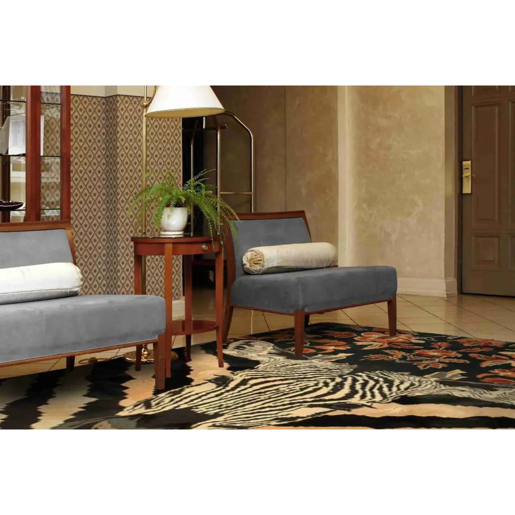 A stylish Zebra Fusion Hand Tufted Area Rug placed in a cozy dining room setting. This large wool rug features an eye-catching zebra pattern with vintage floral details, complementing the elegant furniture and creating a warm, inviting atmosphere perfect for under a dining table.