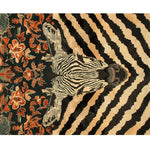 This stunning Zebra Fusion Hand Tufted Area Rug features a bold zebra stripe pattern in black and beige, beautifully complemented by intricate floral designs in rich reds and greens. Perfect as a large area rug for the dining room or under a dining table, this wool rug adds a vintage touch to any space.